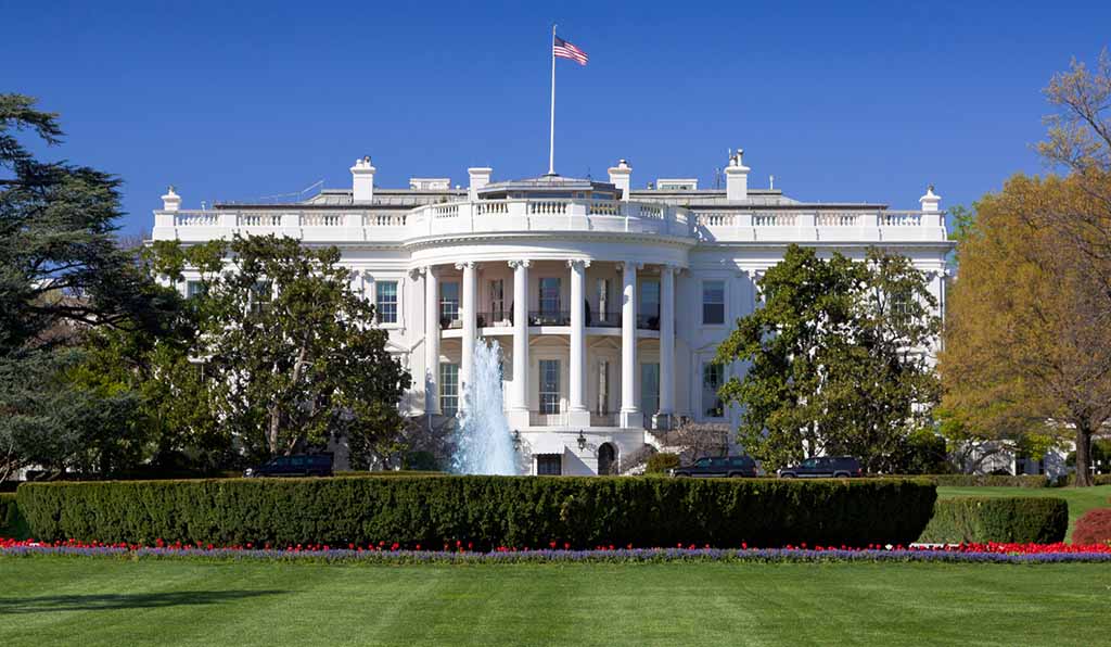 Featured image for blogpost of front view of the White House with an American flag