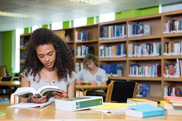 Student reading in library