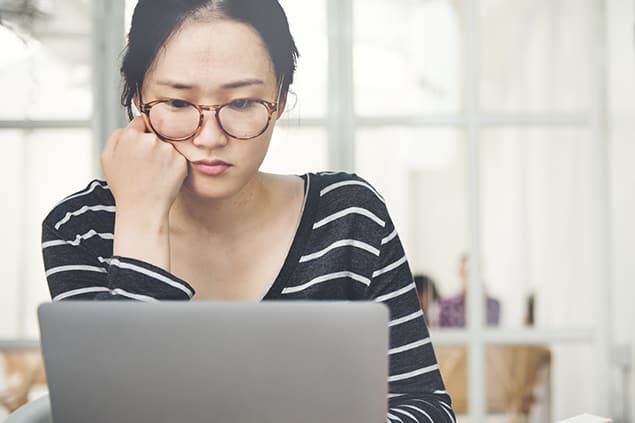 A young woman studying for the TOEFL exam