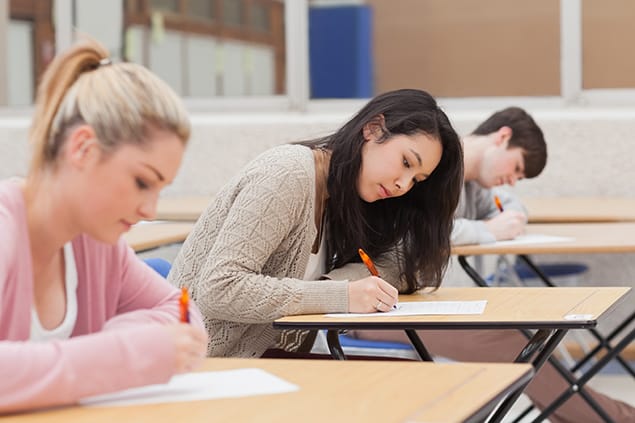 Three students taking the TOEFL Exam