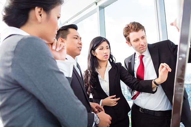 A group of coworkers looking at a chart