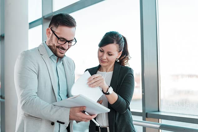 Professional man and woman reviewing documents