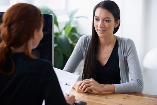 Shot of two young professionals having a discussion at a desk